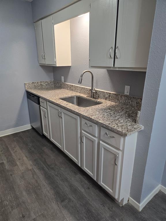718 South Main Street, Unit 3 Paris, TX 75460 - Photo 6 of 6 a kitchen with granite countertop a sink and a white cabinets