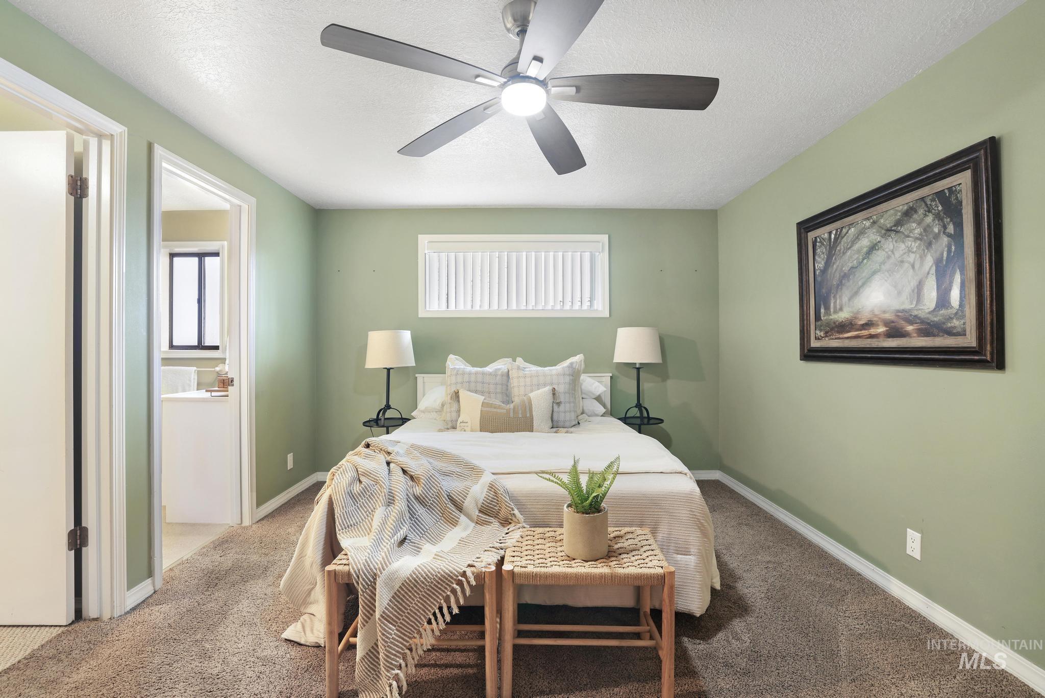 1143 Starfire Street Twin Falls, ID 83301 - Photo 14 of 32 Bedroom featuring carpet, a textured ceiling, ceiling fan, and ensuite bathroom
