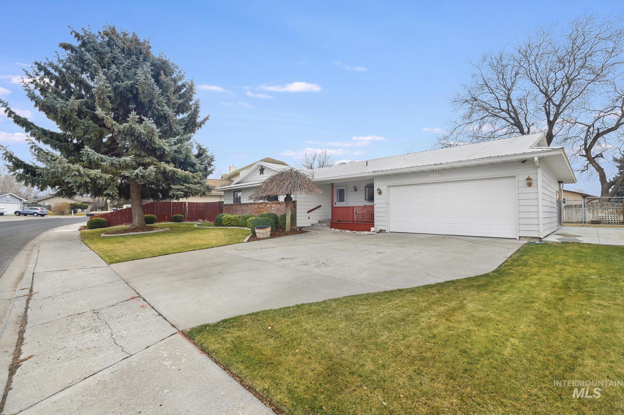 1143 Starfire Street Twin Falls, ID 83301 - Photo 31 of 32 Single story home with concrete driveway, a metal roof, and a garage