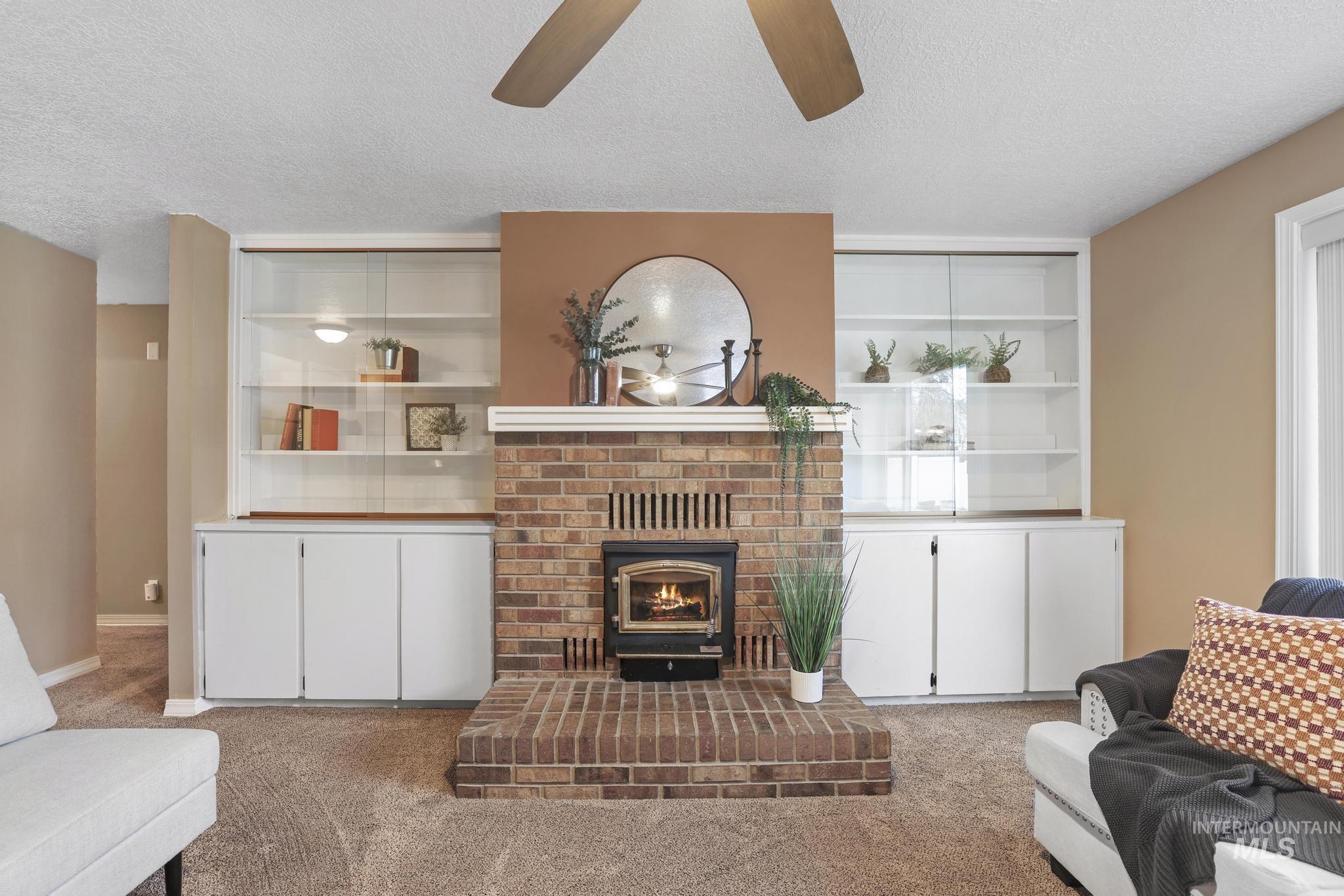 1143 Starfire Street Twin Falls, ID 83301 - Photo 5 of 32 Carpeted living room featuring a textured ceiling and a ceiling fan