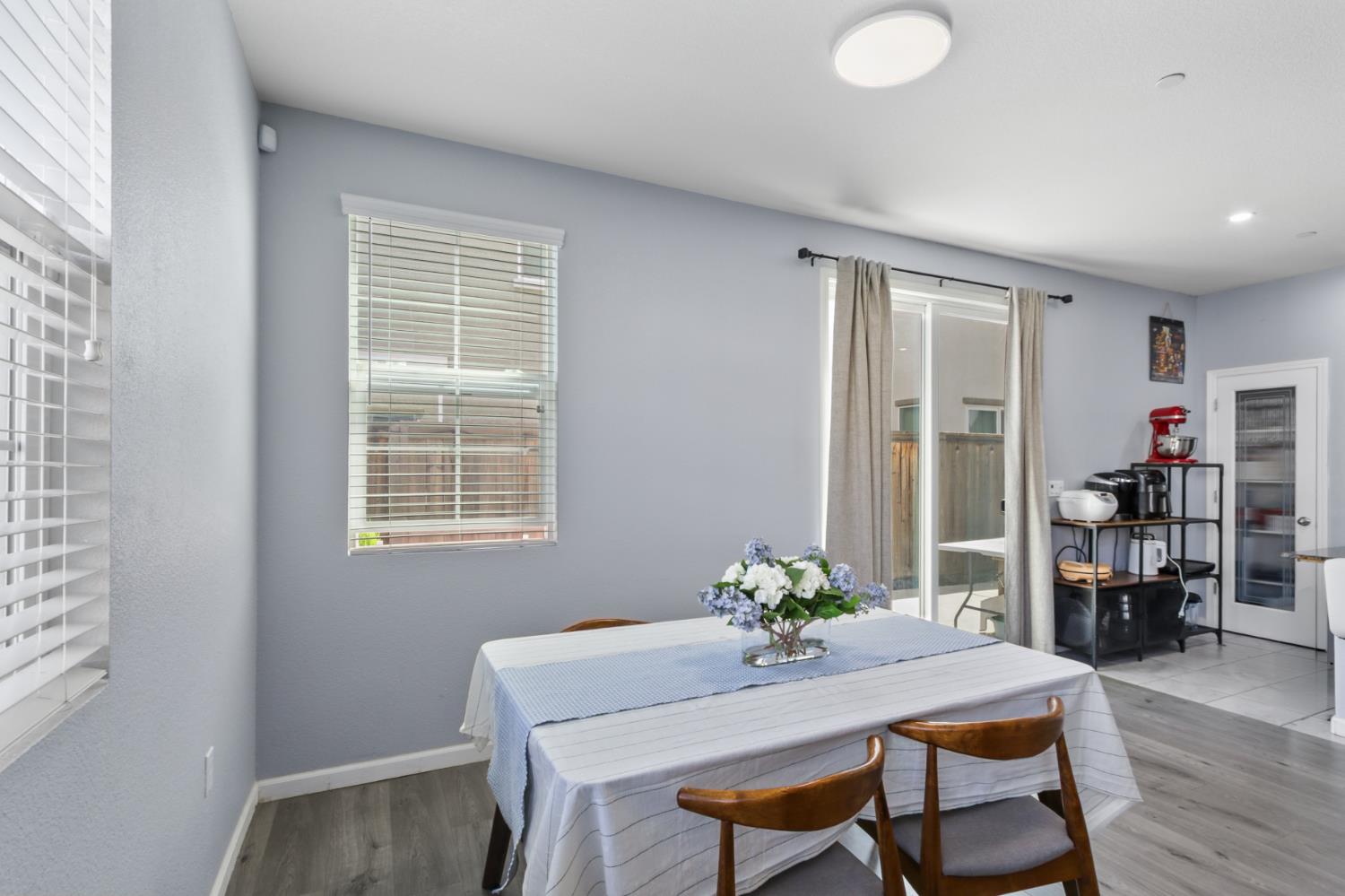 8196 Kramer Ranch Way Elk Grove, CA 95758 - Photo 18 of 47 a dining room with furniture and wooden floor