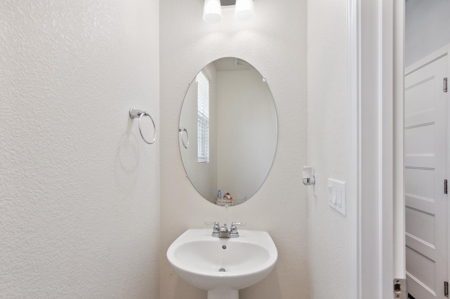 8196 Kramer Ranch Way Elk Grove, CA 95758 - Photo 19 of 47 a bathroom with a sink and a mirror