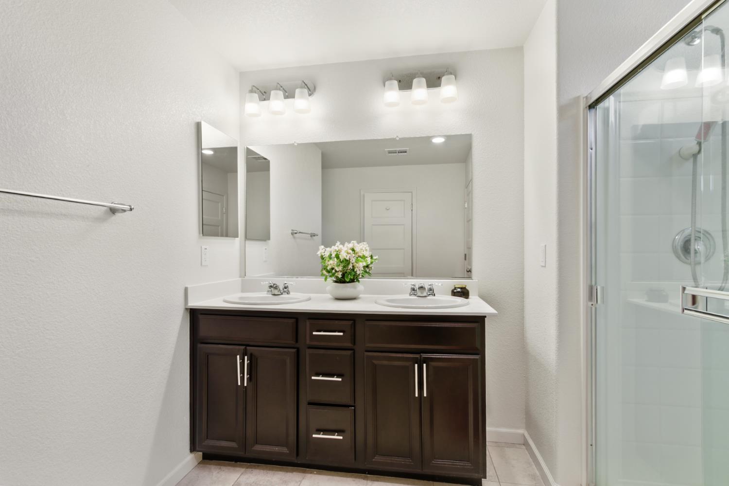 8196 Kramer Ranch Way Elk Grove, CA 95758 - Photo 26 of 47 a bathroom with a sink and a mirror