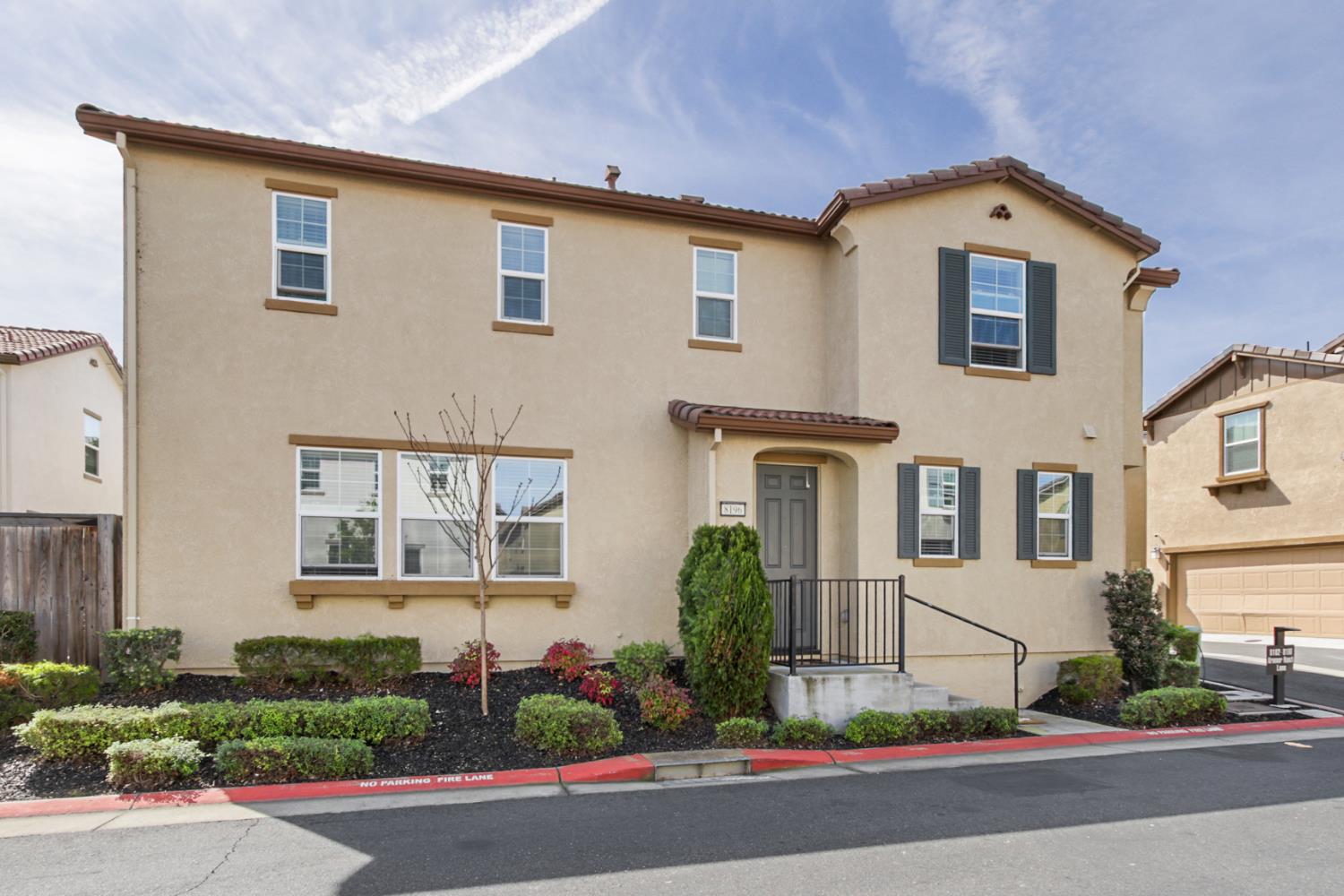 8196 Kramer Ranch Way Elk Grove, CA 95758 - Photo 3 of 47 a front view of a house with a yard and garage