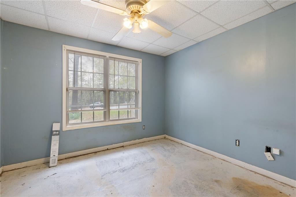 1303 Post Oak Court Winder, GA 30680 - Photo 15 of 25 an empty room with a window and a fan