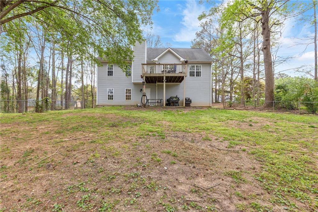 1303 Post Oak Court Winder, GA 30680 - Photo 20 of 25 a view of a big house with a big yard and large trees