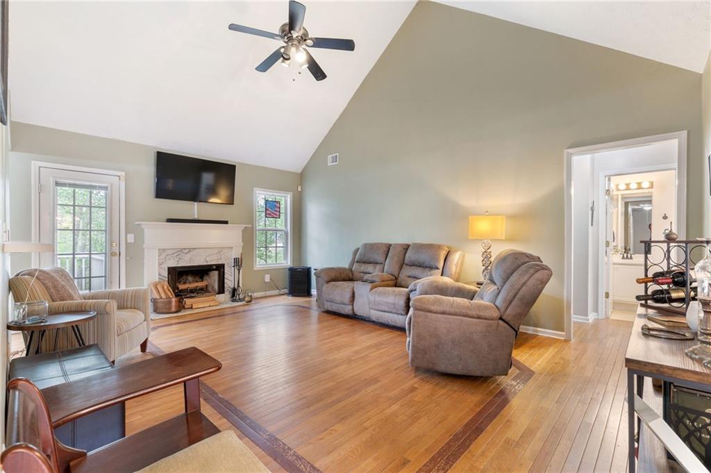 1303 Post Oak Court Winder, GA 30680 - Photo 2 of 25 a living room with furniture a fireplace and a flat screen tv
