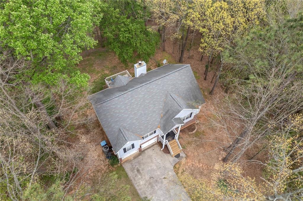 1303 Post Oak Court Winder, GA 30680 - Photo 21 of 25 a view of a backyard with chairs and a tree