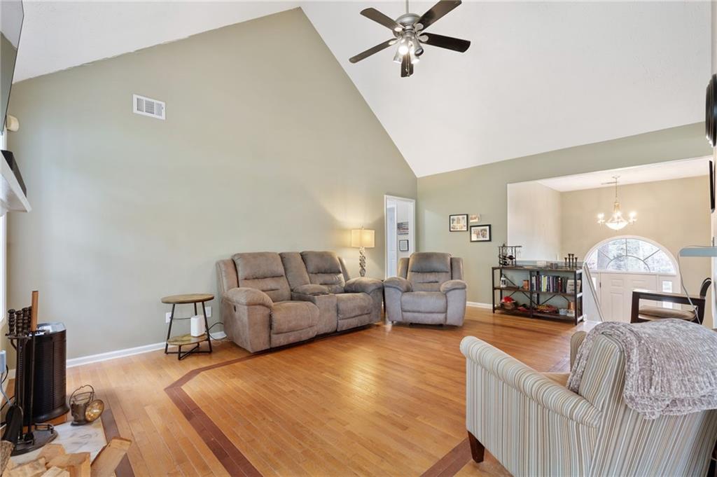 1303 Post Oak Court Winder, GA 30680 - Photo 3 of 25 a bed room with furniture and a chandelier