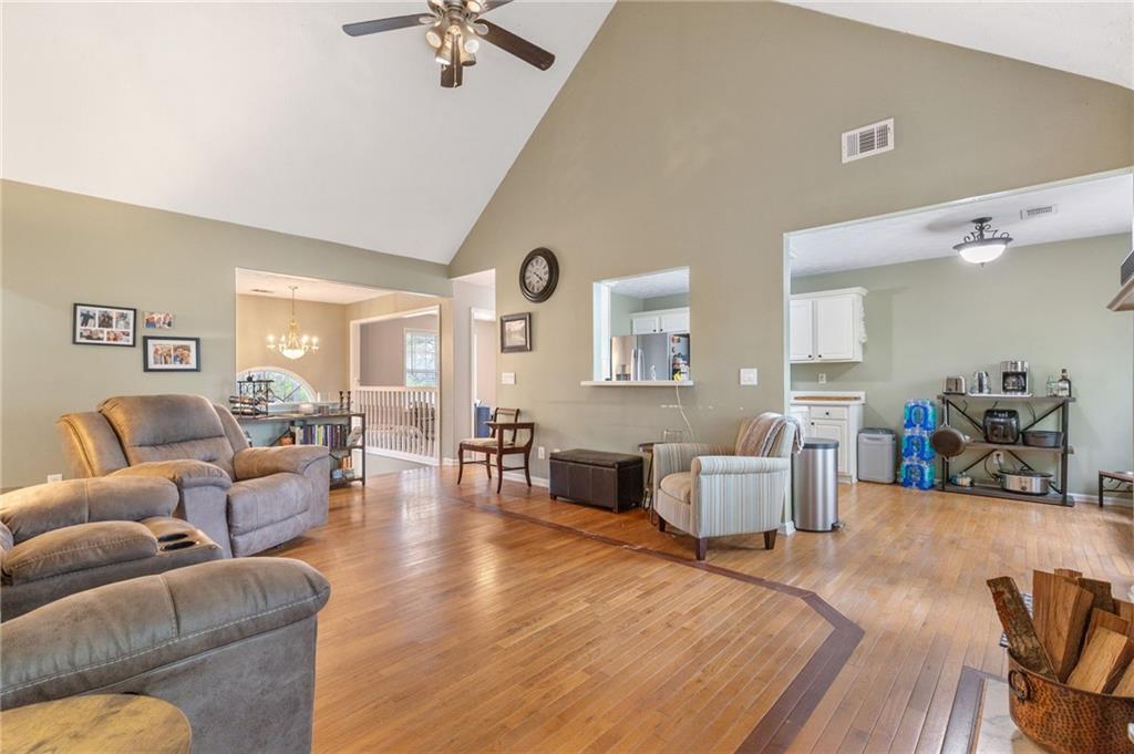 1303 Post Oak Court Winder, GA 30680 - Photo 4 of 25 a living room with furniture and a large mirror with wooden floor
