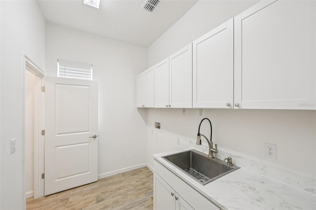 806 Winterside Drive Apollo Beach, FL 33572 - Photo 12 of 57 a kitchen with a sink and cabinets