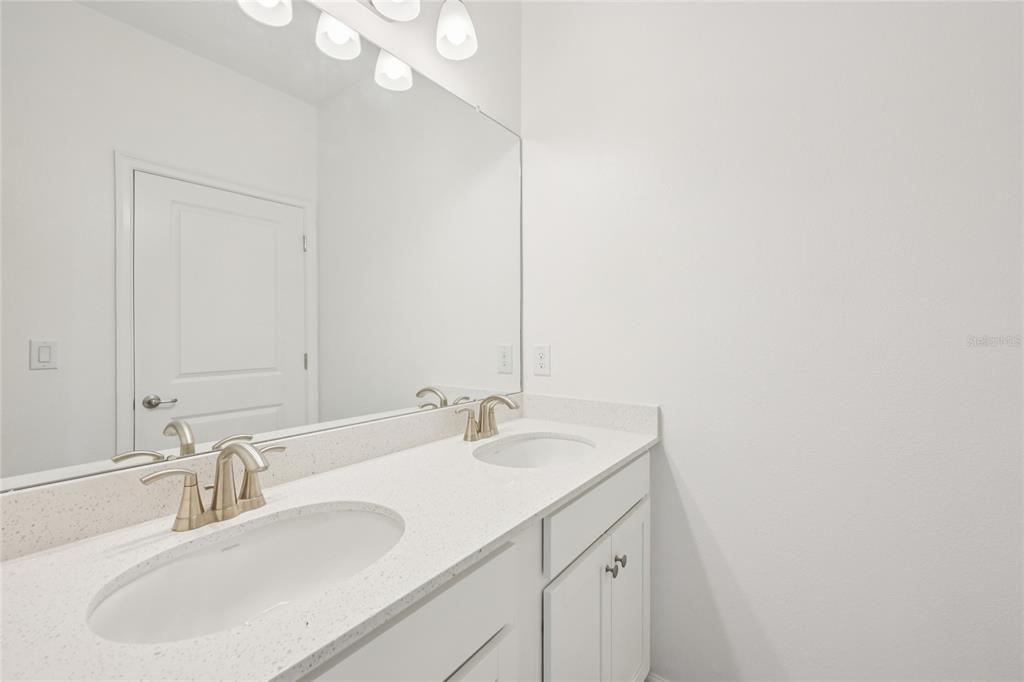 806 Winterside Drive Apollo Beach, FL 33572 - Photo 28 of 57 a bathroom with a sink and a mirror