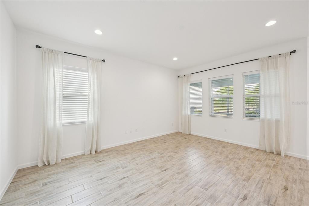 806 Winterside Drive Apollo Beach, FL 33572 - Photo 3 of 57 a view of an empty room with wooden floor and a window