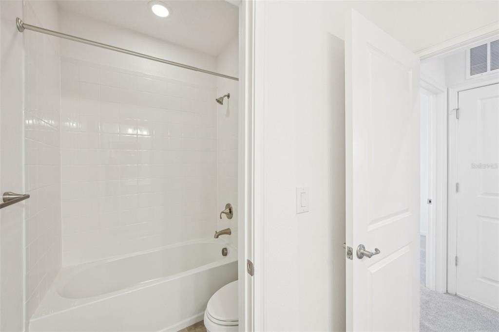 806 Winterside Drive Apollo Beach, FL 33572 - Photo 32 of 57 a bathroom with a bathtub shower vanity and a toilet