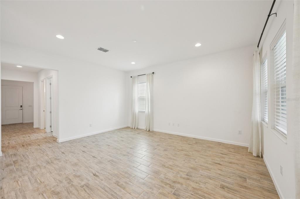 806 Winterside Drive Apollo Beach, FL 33572 - Photo 5 of 57 an empty room with wooden floor and windows