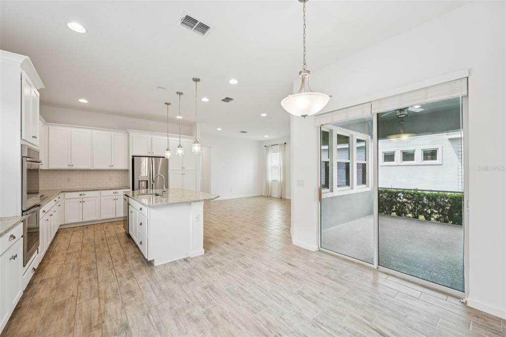 806 Winterside Drive Apollo Beach, FL 33572 - Photo 6 of 57 a view of a living room and kitchen with stainless steel appliances