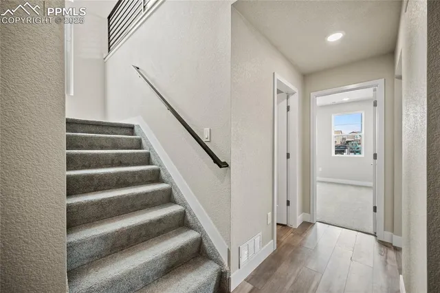 a view of entryway with wooden floor and stairs