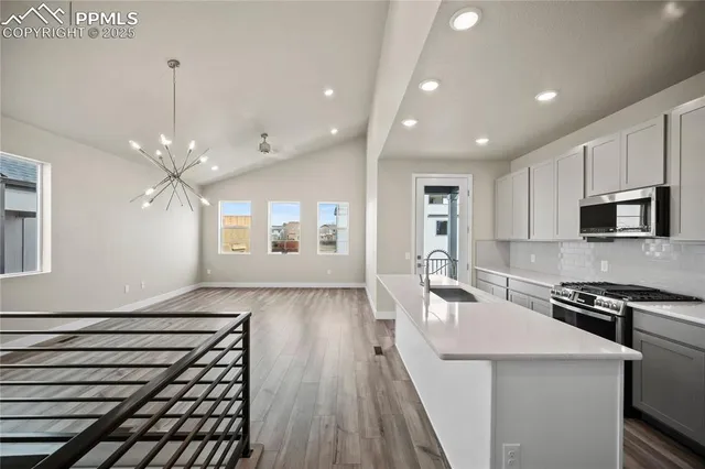a kitchen with sink microwave and stove