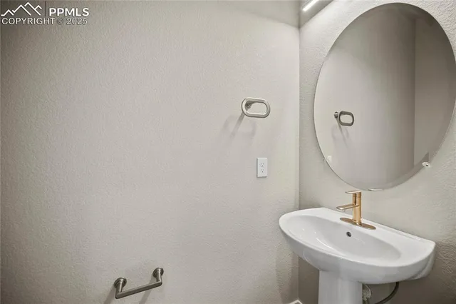 a bathroom with a sink and mirror