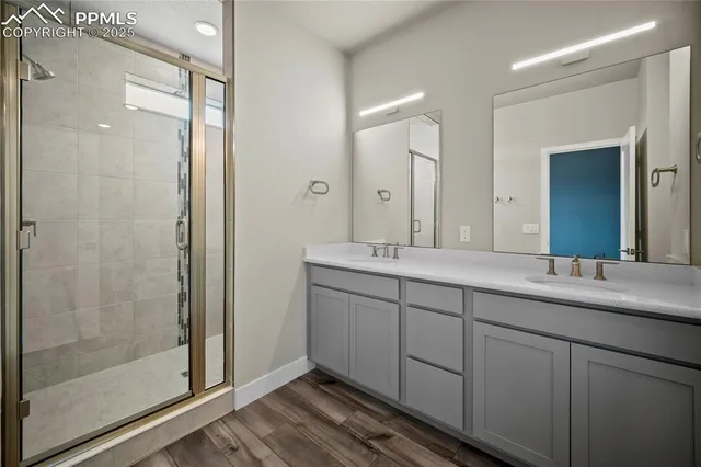 a bathroom with double sink and a mirror