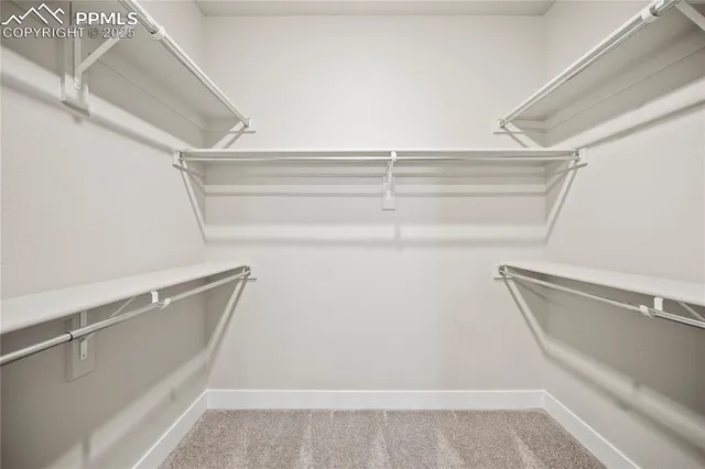 a view of walk in closet with empty racks