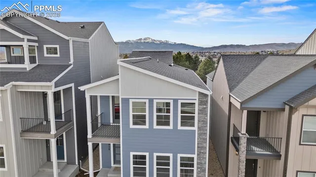 a view of a big house with a mountain view and balcony