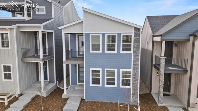 a front view of a house with many windows