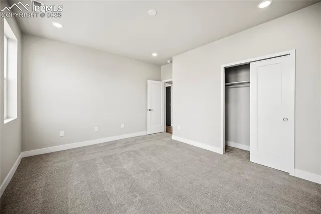 an empty room with closet and a bathroom