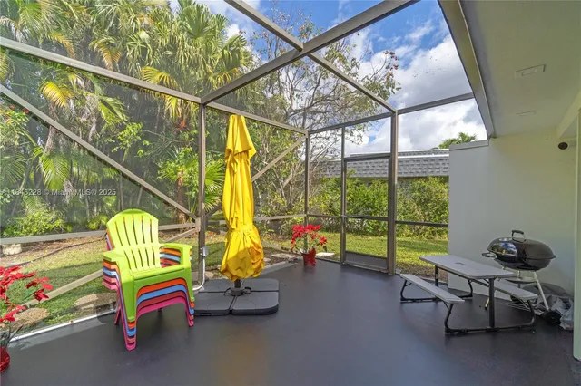 a sitting area with swimming pool in the back