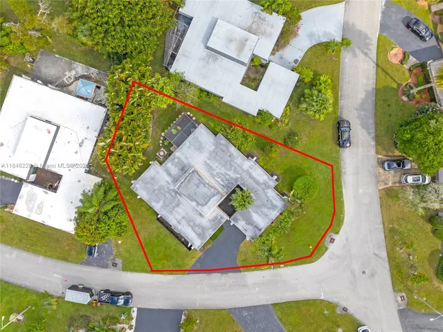 an aerial view of a house with a swimming pool