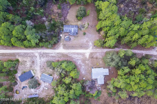 an aerial view of a house with a yard and garden