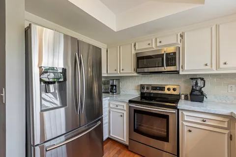 a stove top oven sitting inside of a kitchen