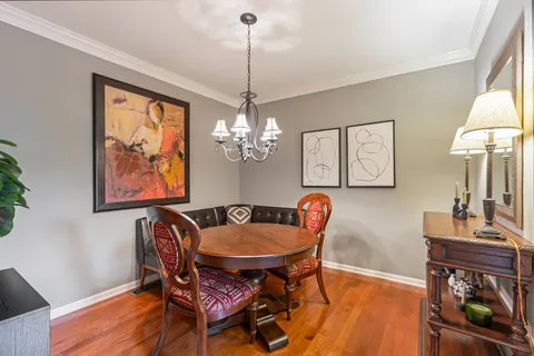 a view of a dining room with furniture and chandelier