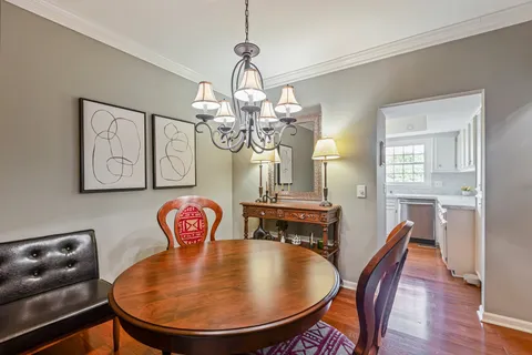 a bedroom with a large bed and a potted plant