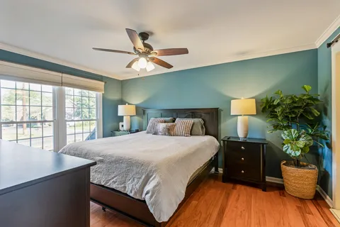 a bedroom with a bed and a chandelier