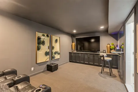 a view of a patio with a table and chairs and wooden fence