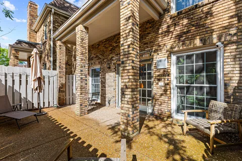 a view of a patio with a table and chairs