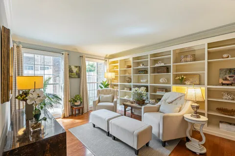 a living room with furniture and a floor to ceiling window