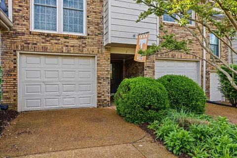 front view of a brick house with a large door
