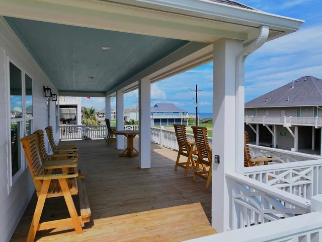 a view of a chairs and table on the wooden deck
