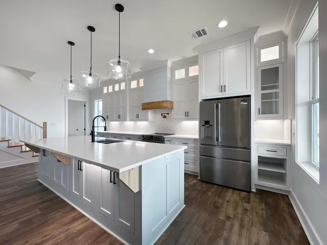 a view of a kitchen with a sink and dishwasher wooden floor