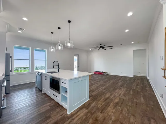 a kitchen with granite countertop a stove and a sink