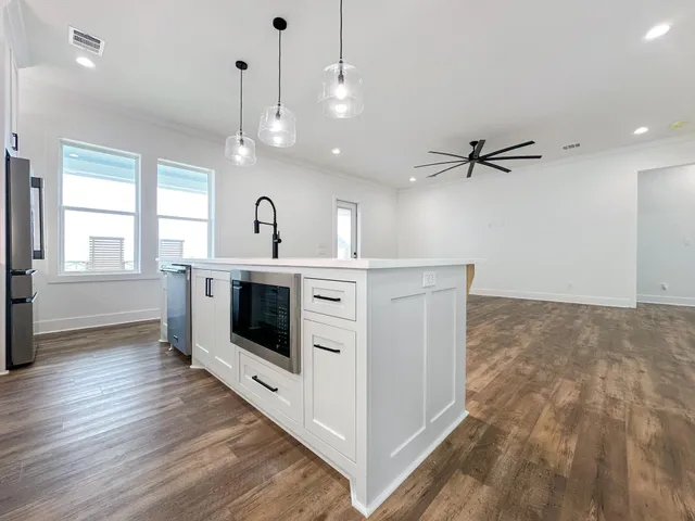 a kitchen with a sink and a stove top oven