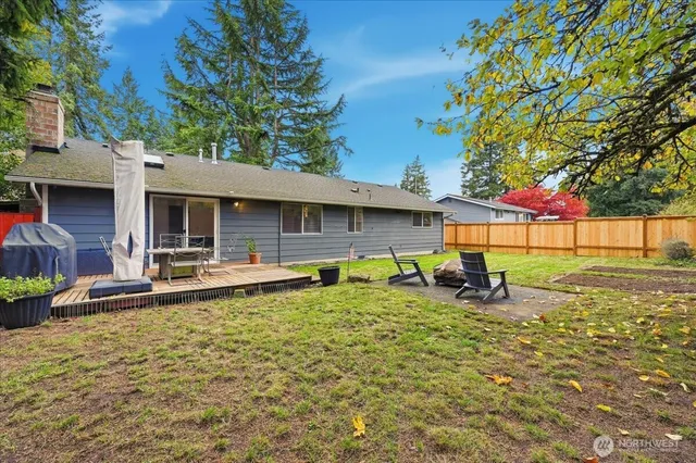 a backyard of a house with table and chairs