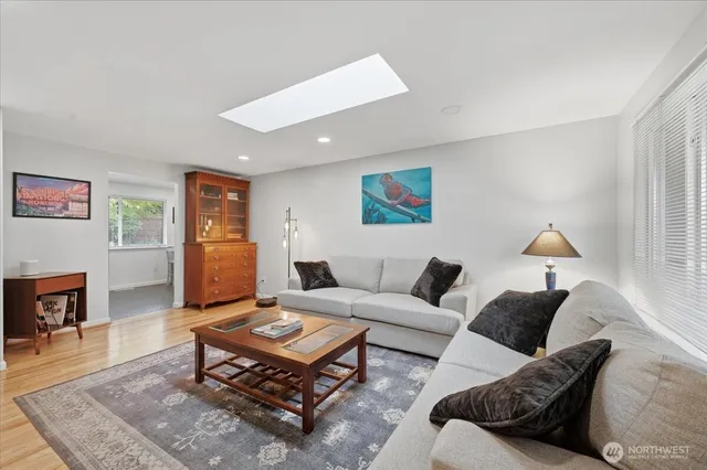 a living room with furniture a table and a flat screen tv