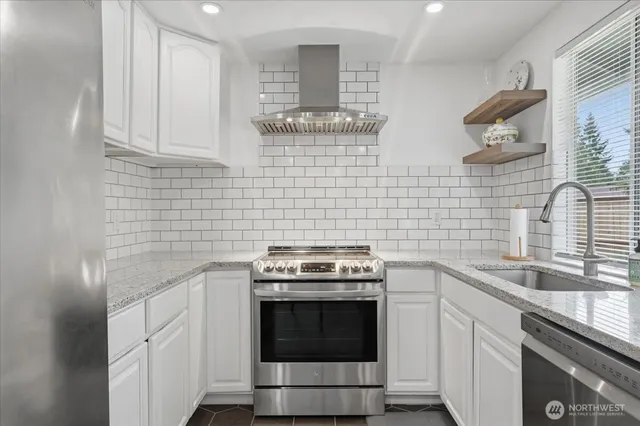 a kitchen with cabinets stainless steel appliances and a sink