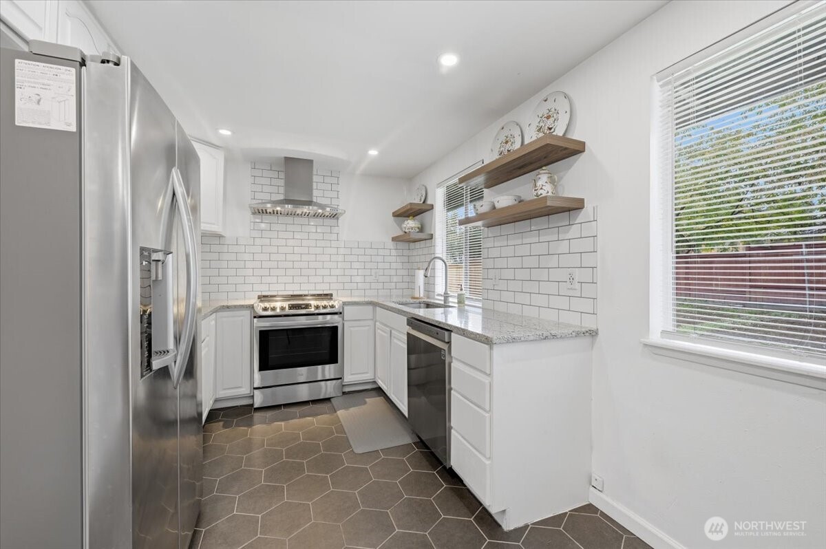 611 216th Street Southwest Bothell, WA 98021 - Photo 9 of 22 a kitchen with a stove and a refrigerator