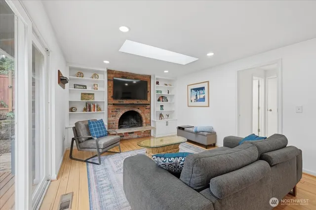 a living room with furniture a fireplace and a flat screen tv