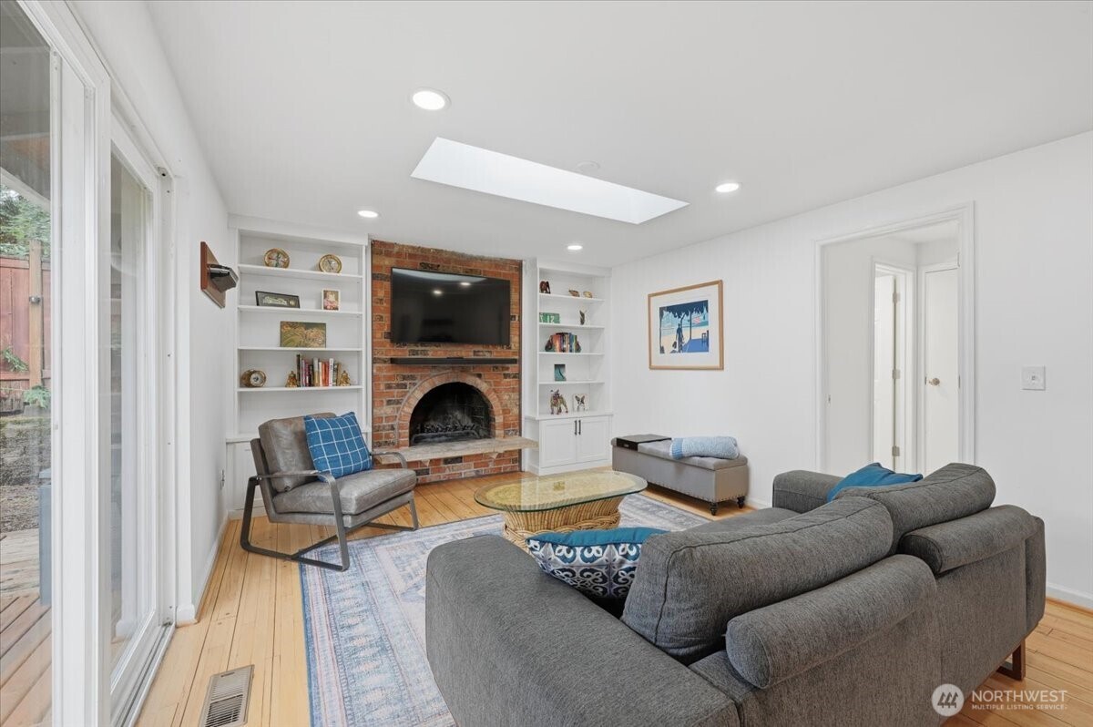 611 216th Street Southwest Bothell, WA 98021 - Photo 10 of 22 a living room with furniture a fireplace and a flat screen tv