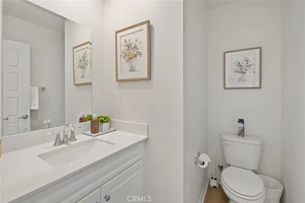 a white toilet sitting next to a bathroom sink